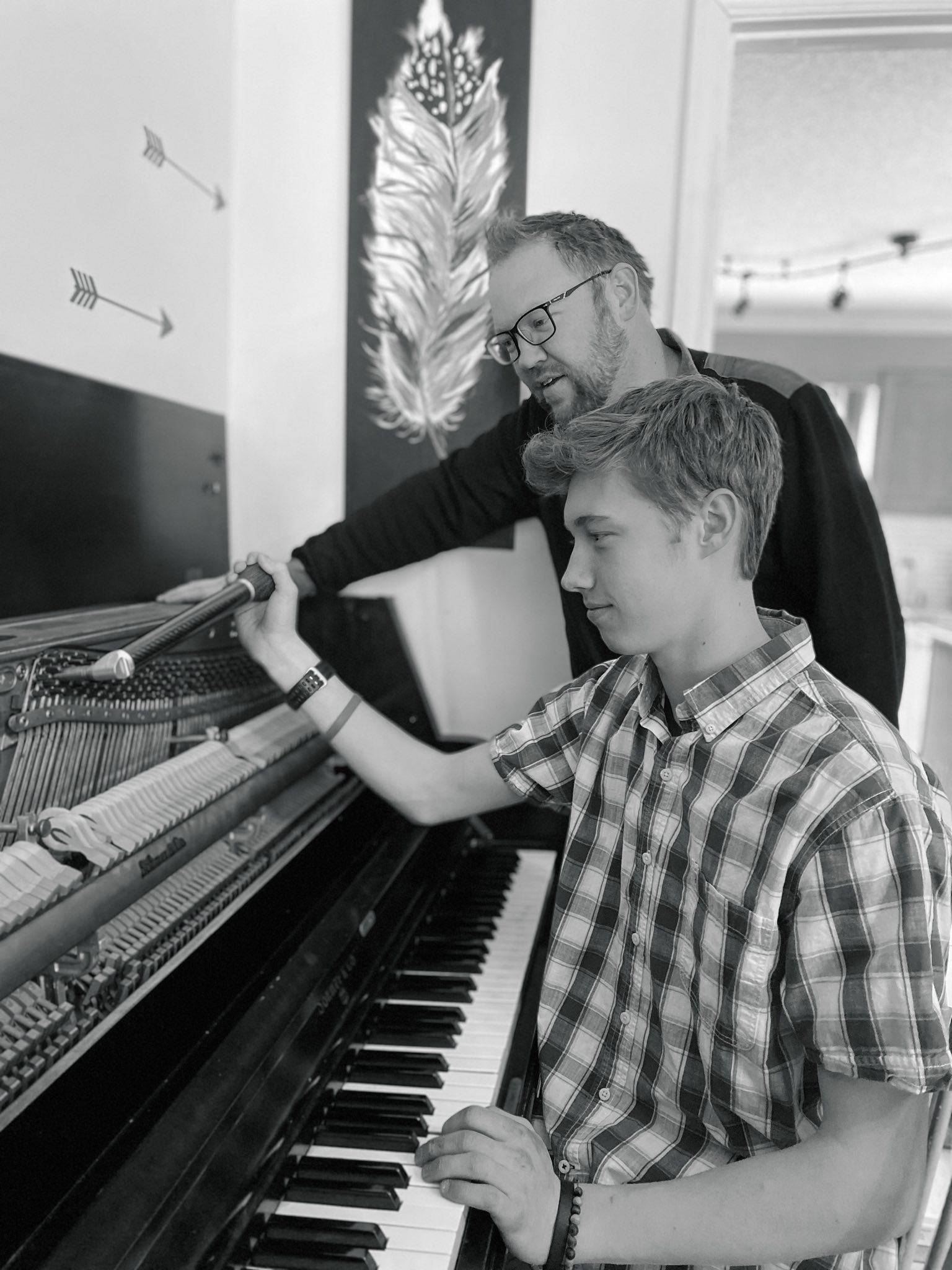 Josh and Benji Kemp working on a piano together